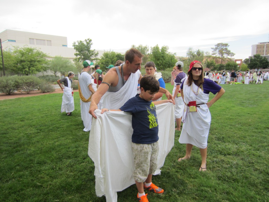 Greg Stemm, aka Prime, helps Christopher with his toga.